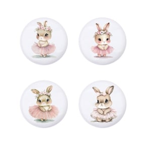 May include: Four round stickers featuring watercolor illustrations of bunnies wearing pink tutus and floral headbands. The bunnies are all facing forward with their ears up.