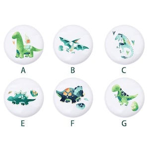 May include: Six round white buttons with different dinosaur illustrations. Each button has a letter label: A, B, C, E, F, and G.