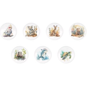 May include: Set of six round ceramic coasters featuring watercolor illustrations of Australian animals, including a koala, a wombat, a kookaburra, a dolphin, a kangaroo, and a sea turtle.