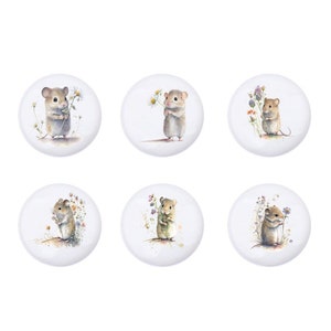 May include: Six round white ceramic tiles featuring watercolour illustrations of mice holding flowers. Each tile depicts a mouse in a different colour and with a unique expression.
