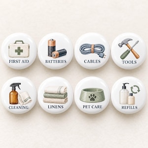 May include: Eight white circular labels with illustrations and text. The labels feature icons for First Aid, Batteries, Cables, Tools, Cleaning, Linens, Pet Care, and Refills, each with corresponding black text labels centred below the graphic.