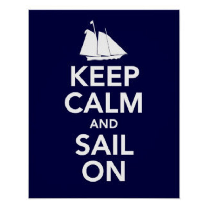 May include: A navy blue poster with a white sailboat and the text "Keep Calm and Sail On".