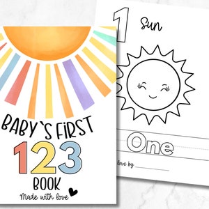 May include: A colorful baby's first 123 book with a sun illustration on the cover. The book has a watercolor-style background and the numbers 1, 2, and 3 are in different colors. The text reads "Baby's First 123 Book Made with Love".