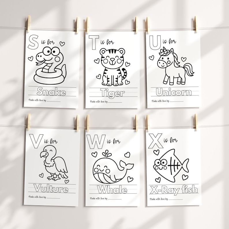 May include: Six white paper prints, each featuring a letter of the alphabet and a corresponding animal illustration in black outline. The letters are S, T, U, V, W, and X. Each print includes the animal's name and a space for writing.