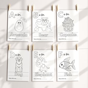 May include: Black and white printable alphabet flashcards with illustrations for each letter. The letters A through F are shown with the corresponding word below each letter. The illustrations include an avocado, bear, cupcake, dog, elephant, and fish.