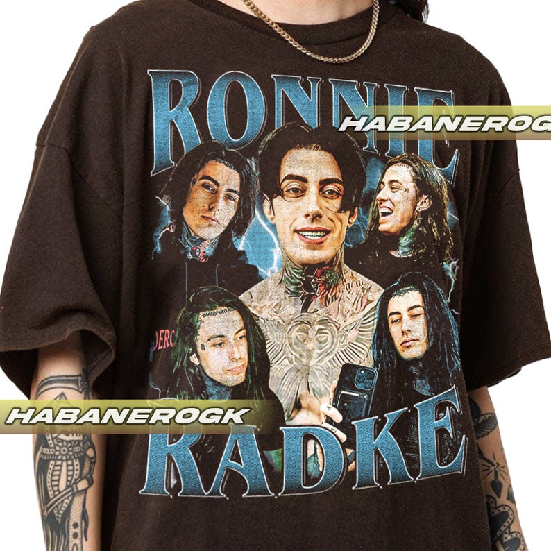 a man wearing a black shirt with a picture of a group of people on it