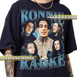 a man wearing a black shirt with a picture of a group of people on it