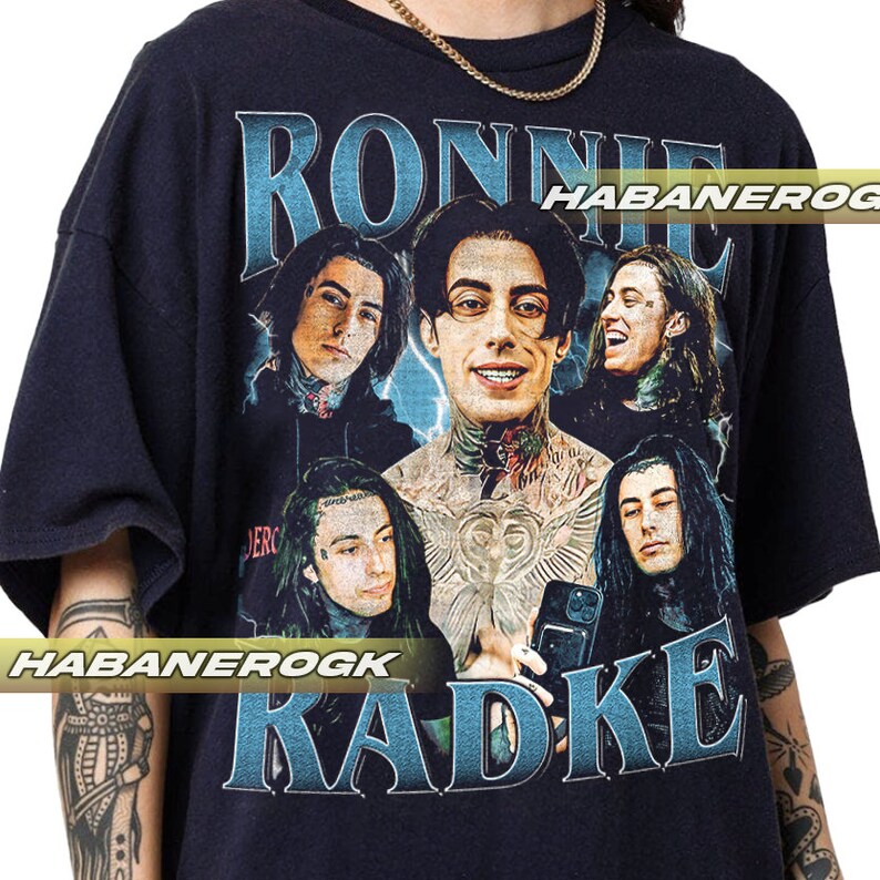 a man wearing a black shirt with a picture of a group of people on it