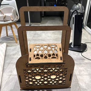 May include: A wooden decorative shelf with intricate geometric patterns cut into the wood. The shelf has two levels and is made of light brown wood.