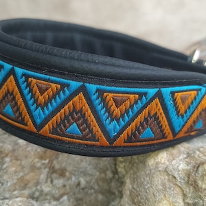 May include: Black leather dog collar with a blue, orange and brown geometric pattern.