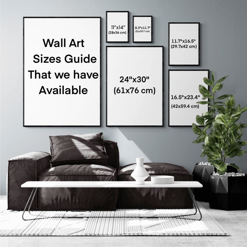 May include: Wall art sizes guide with different sizes listed in inches and centimeters. The guide is displayed on a wall with a couch and a plant in front of it.