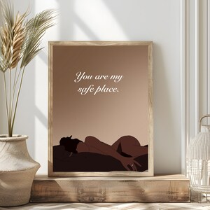 May include: A digital art print with a brown background and a silhouette of a person lying down. The text "You are my safe place." is written in white on the print.
