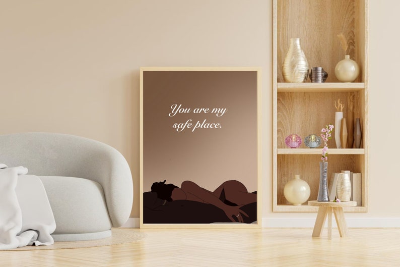 May include: A framed illustration of a person lying down with the text "You are my safe place." The illustration is on a brown background with a light brown frame.