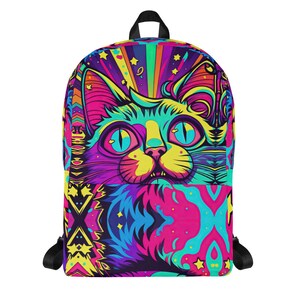 May include: A vibrant backpack featuring a psychedelic cat design. The cat's face is rendered in bright colors, including pink, yellow, blue, and purple. The backpack has black straps and a top handle, with a colorful geometric pattern on the lower half.