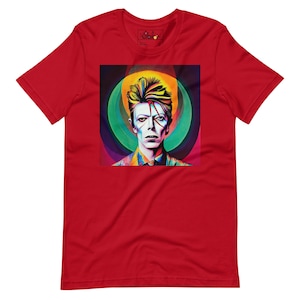 May include: Red t-shirt with a colorful image of David Bowie in a circle design.