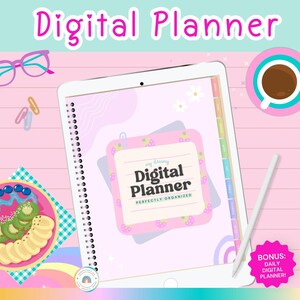 May include: A digital planner displayed on a white tablet with the text "Digital Planner" in pink. The planner has a pink and light purple design with a strawberry theme. A white stylus, a cup of coffee, and a plate of fruit are also visible.