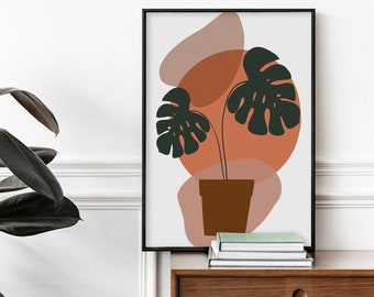 May include: A framed print with a minimalist design featuring a potted plant with large green leaves against a background of abstract shapes in shades of orange, pink, and brown.