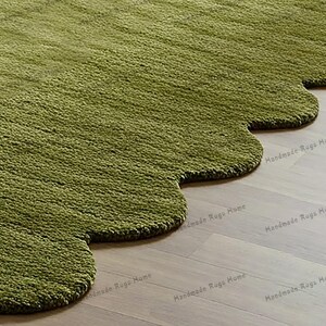 Luxurious green hand-tufted rug with soft texture, ideal for living rooms or bedrooms.