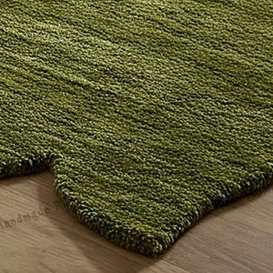 Vibrant green hand-tufted area rug, designed to add a pop of color to any space.