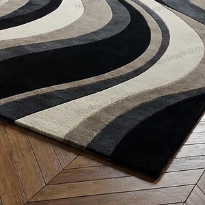 Modern designer rug adding contrast to deep blue walls,

Abstract sculptural carpet ideal for contemporary décor,

Plush textured wool area rug with dramatic color flow,

Elegant monochrome floor accent in luxury apartment,

Statement interior styling with premium tufted rug