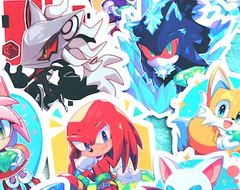 May include: A collection of colorful stickers featuring various characters from the Sonic the Hedgehog video game series. The stickers showcase characters like Sonic, Tails, Knuckles, and others, with vibrant colors and dynamic poses. The stickers are on a light blue background.