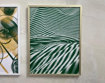 May include: A framed print of a green and white striped pattern. The pattern is abstract and appears to be a close-up of fabric.