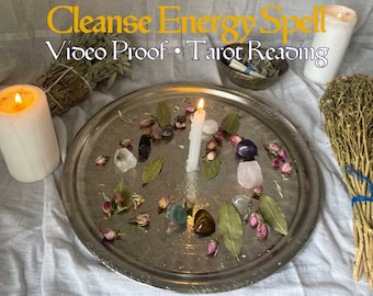 Può includere: Un vassoio d'argento con una candela bianca, cristalli, erbe secche e petali di rosa. Il testo "Cleanse Energy Spell Video Proof Tarot Reading" è in alto nell'immagine.