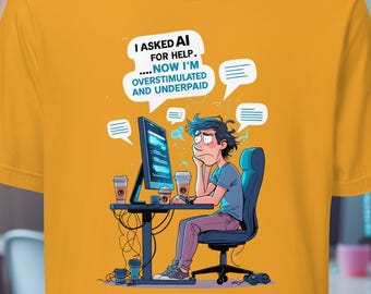 May include: A mustard yellow t-shirt featuring a graphic illustration of a person sitting at a computer desk with multiple speech bubbles and the text: I ASKED AI FOR HELP. ....NOW I'M OVERSTIMULATED AND UNDERPAID. The design includes coffee cups and cables.