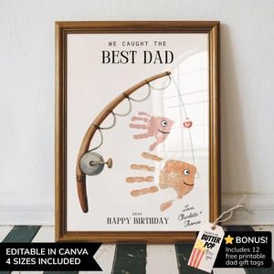 May include: A framed print featuring a fishing rod illustration with two handprint fish, the text WE CAUGHT THE BEST DAD, 20XX, HAPPY BIRTHDAY, and Love, Charlotte + Thomas. A small tag attached to the frame reads BUTTER POP and BONUS.