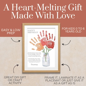 May include: A framed print featuring a handprint bouquet in red and orange, with a mason jar illustration, the text HAPPY BIRTHDAY, a poem, and the name Thomas. The print is displayed in a light wood frame against a two-tone background.