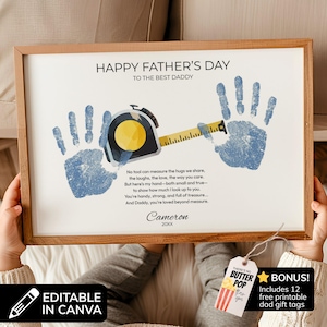 May include: A framed Father's Day print featuring two blue handprints, a yellow tape measure graphic, and the text: HAPPY FATHER'S DAY TO THE BEST DADDY. It includes a poem, the name Cameron, and the year 20XX, with a bonus gift tag attached.
