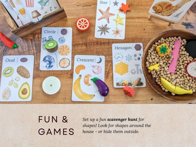 May include: A set of colorful wooden shapes and cards with illustrations of different shapes. The cards have the words "Oval", "Circle", "Crescent", "Star", and "Hexagon" printed on them. The text "FUN & GAMES" is printed on a brown surface below the cards. The text "Set up a fun scavenger hunt for shapes! Look for shapes around the house - or hide them outside." is printed below the text "FUN & GAMES".