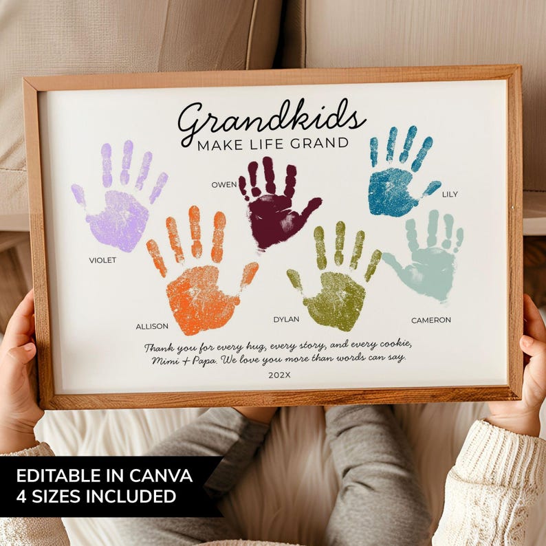 May include: A framed print featuring the text Grandkids MAKE LIFE GRAND with five colourful handprints in purple, orange, dark red, olive green, and light blue. Each handprint is labelled with names: Violet, Allison, Owen, Dylan, and Cameron.