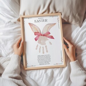 a mother holding a framed bunny handprint craft preschool printable