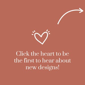 May include: A terracotta-coloured graphic featuring a white hand-drawn heart icon with radiating lines above it, a white curved arrow pointing toward the heart, and the white text: Click the heart to be the first to hear about new designs!