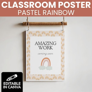 May include: A classroom poster with the text "CLASSROOM POSTER PASTEL RAINBOW" at the top. The poster has a pastel rainbow design and the words "AMAZING WORK coming soon". The poster is hanging from a wooden dowel.