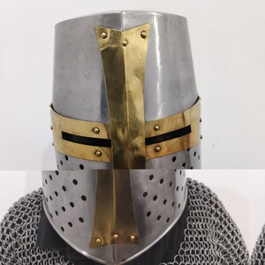 May include: A silver helmet with a gold cross design. The helmet has a pointed top and a visor with small holes.