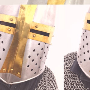 May include: A silver and gold knight helmet with a chainmail collar. The helmet has a cross design on the front and is perforated with small holes.