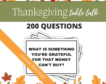 May include: A printable Thanksgiving table talk game with 200 questions. The game features a white card with black text that reads "What is something you're grateful for that money can't buy?" The card is surrounded by a border of fall leaves and berries.