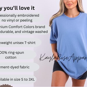 May include: A light blue, heavyweight unisex T-shirt. The shirt is garment-dyed and made of 100% ring-spun cotton. The text "Kayla Rose Apparel" is visible on the shirt. Available in sizes S to 3XL.