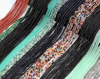 May include: Assortment of colorful gemstone beads, including black, green, red, and multi-colored strands. The beads are strung on thin wire and are perfect for jewelry making.