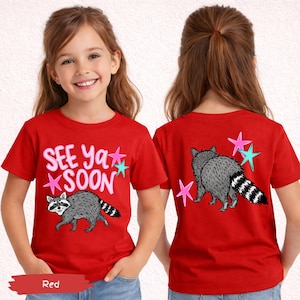 May include: Red t-shirt with a raccoon graphic and the text "SEE Ya SOON". The back of the shirt features a raccoon and star graphics. The shirt is made of a soft material.