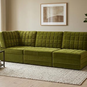 May include: A modular sectional sofa upholstered in olive green velvet fabric featuring a grid-tufted pattern on the backrests and seat cushions. The sofa consists of three connected sections, including a corner piece, with a low-profile design.