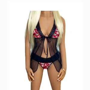 May include: Black lingerie set with a sheer, flowing design. The bra and panty feature a red and white pattern with the word "Alabama" and the letter "A". The set includes a matching sheer cover-up.