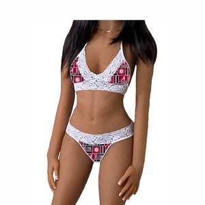 May include: White lace lingerie set featuring a halter-style bralette and matching thong. The fabric has a pattern of red, black, and white squares with the letter "A" and the words "Crimson Tide".