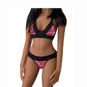 May include: Black lace lingerie set with a red and black print featuring the University of Georgia Bulldogs logo and the words "UGA" and "Georgia".
