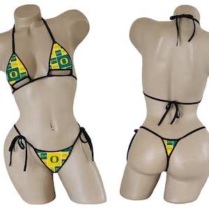 May include: Black bikini with a green and yellow patterned design featuring the letter "O".