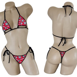 May include: A red and black bikini with a repeating pattern of the University of Georgia logo. The bikini top is a triangle style with adjustable straps. The bikini bottom is a thong style with adjustable ties on the sides.