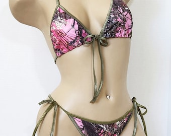 May include: Pink and green camouflage print bikini top and bottom with green ties.