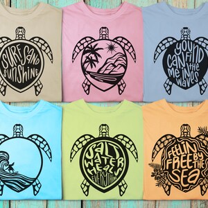 May include: Six different t-shirts with a sea turtle design and a phrase inside the turtle shell. The phrases are "Surf Sand Sunshine", "You Can Find Me In The Waves", "Salt Water Heals Everything", "Feelin Free By The Sea",  "Surf Sand Sunshine", and "You Can Find Me In The Waves".
